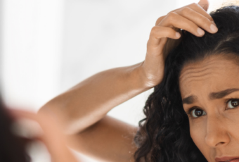 woman looking at hair loss