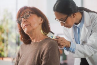 woman getting a skin cancer screening near Foxborough