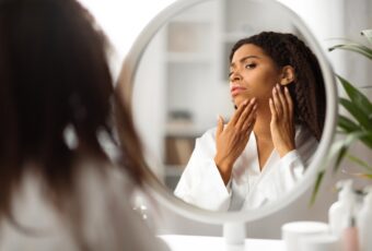 woman wondering why skin breaking out even though she isn't a teenager